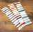 Set of colorful thread spools on a wooden surface with 'Leistitch' branding.