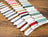 Color swatch cards with embroidery threads on a wooden surface