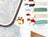 Collection of embroidery threads and a cross-stitch hoop on a wooden surface.