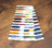 Color swatch card with various threads on a wooden surface