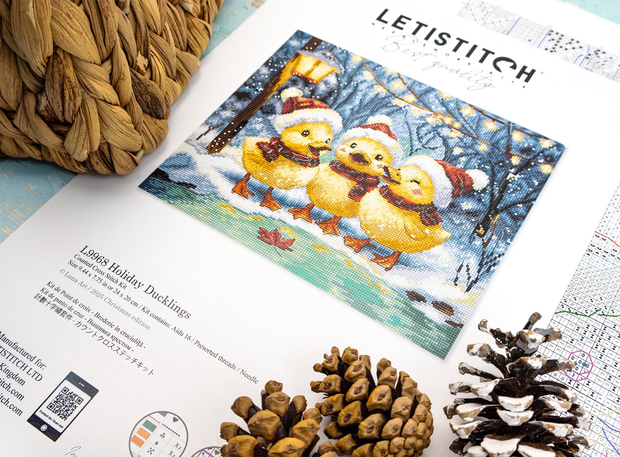 Cross-stitch kit with 'Letistitch' branding featuring three yellow ducks in winter attire on a snowy background.