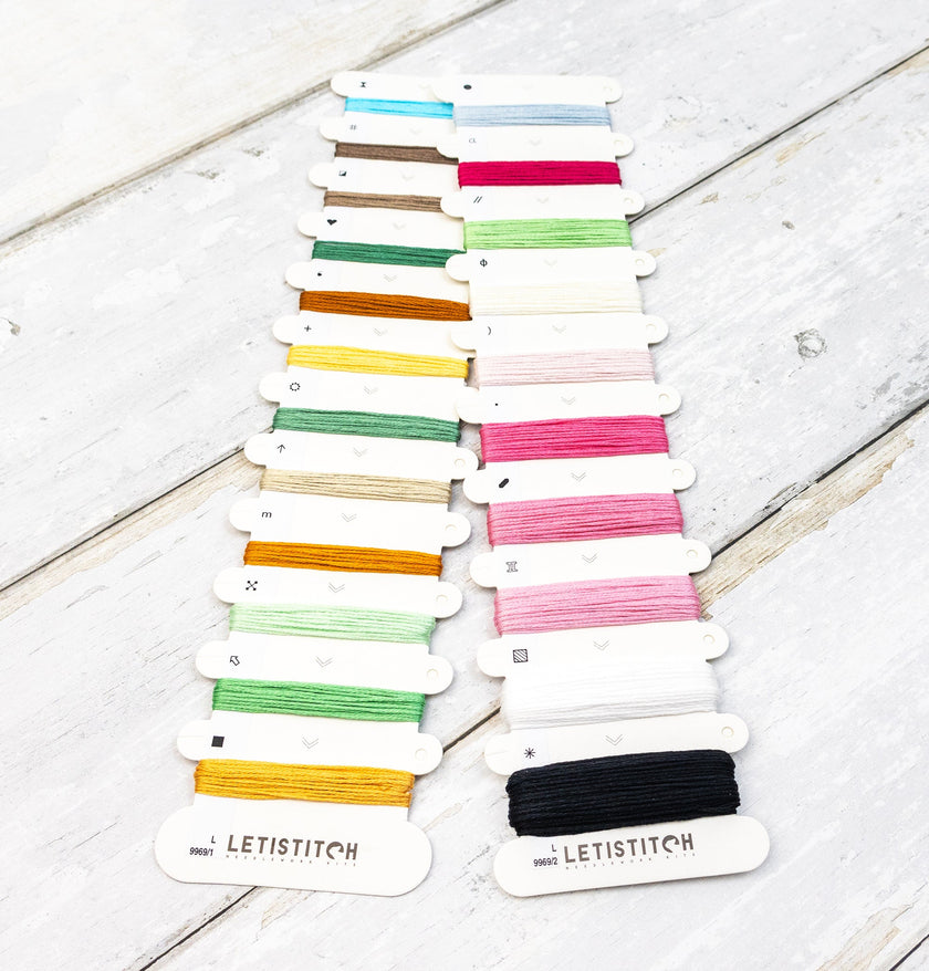 Set of colorful embroidery threads on cards with 'LETISTITCH' branding on a wooden surface.