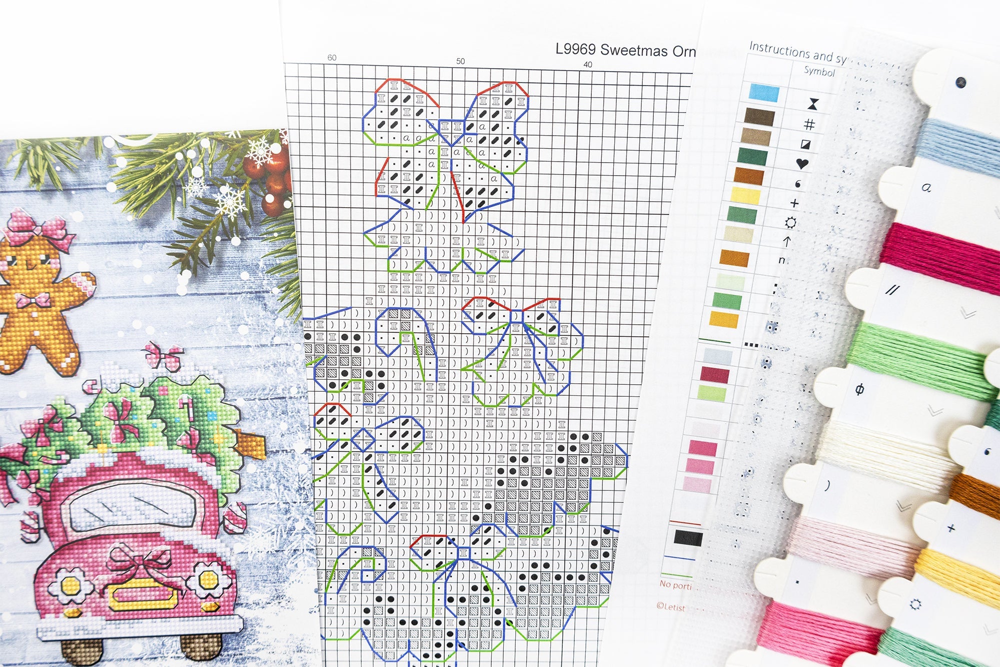 Cross-stitch pattern with Christmas-themed designs and embroidery threads.