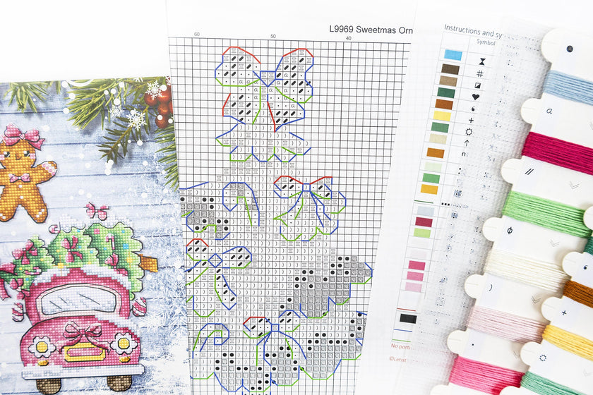 Cross-stitch pattern with Christmas-themed designs and embroidery threads.