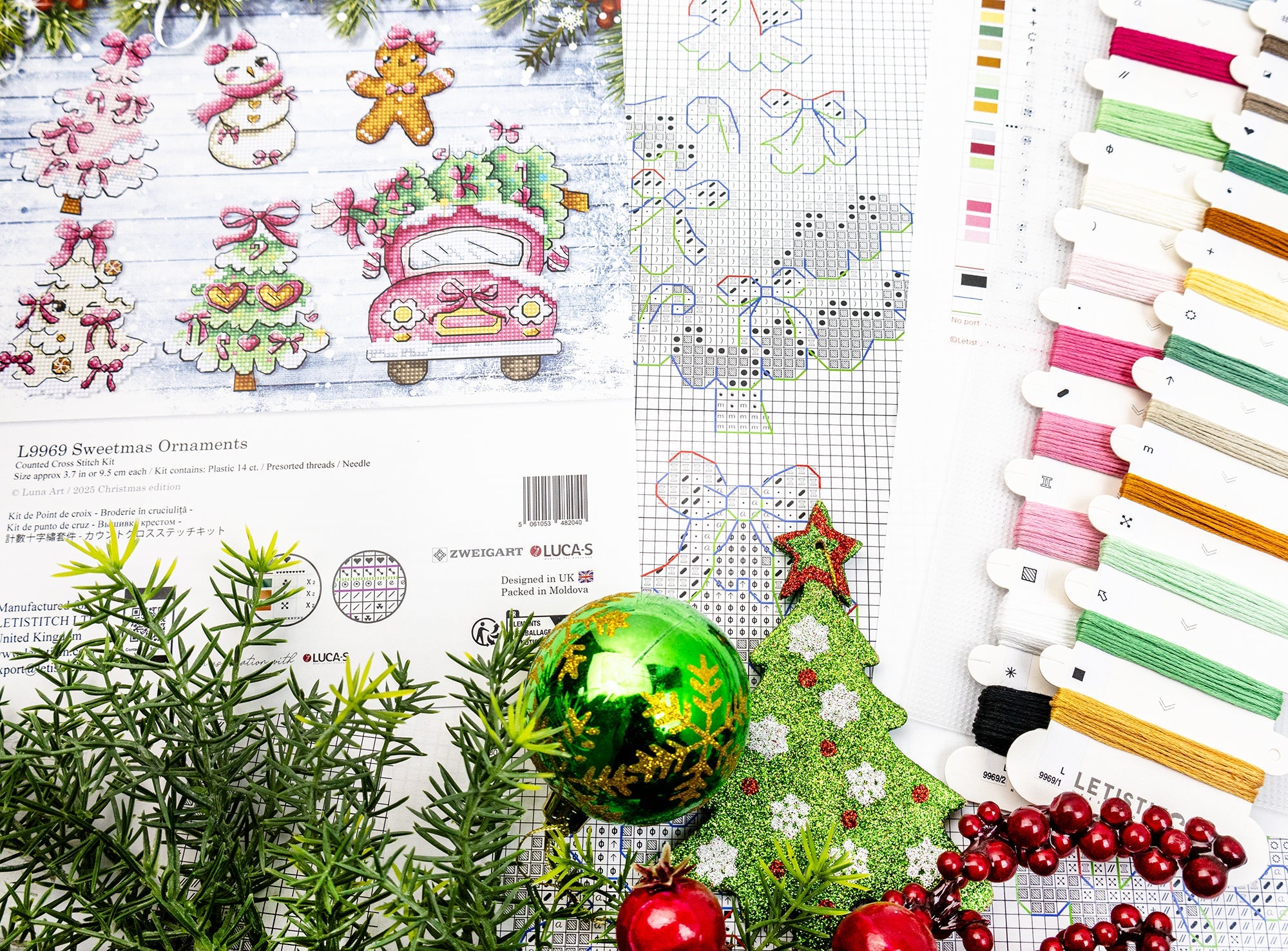Cross-stitch pattern with Christmas-themed designs and embroidery floss on a white background.