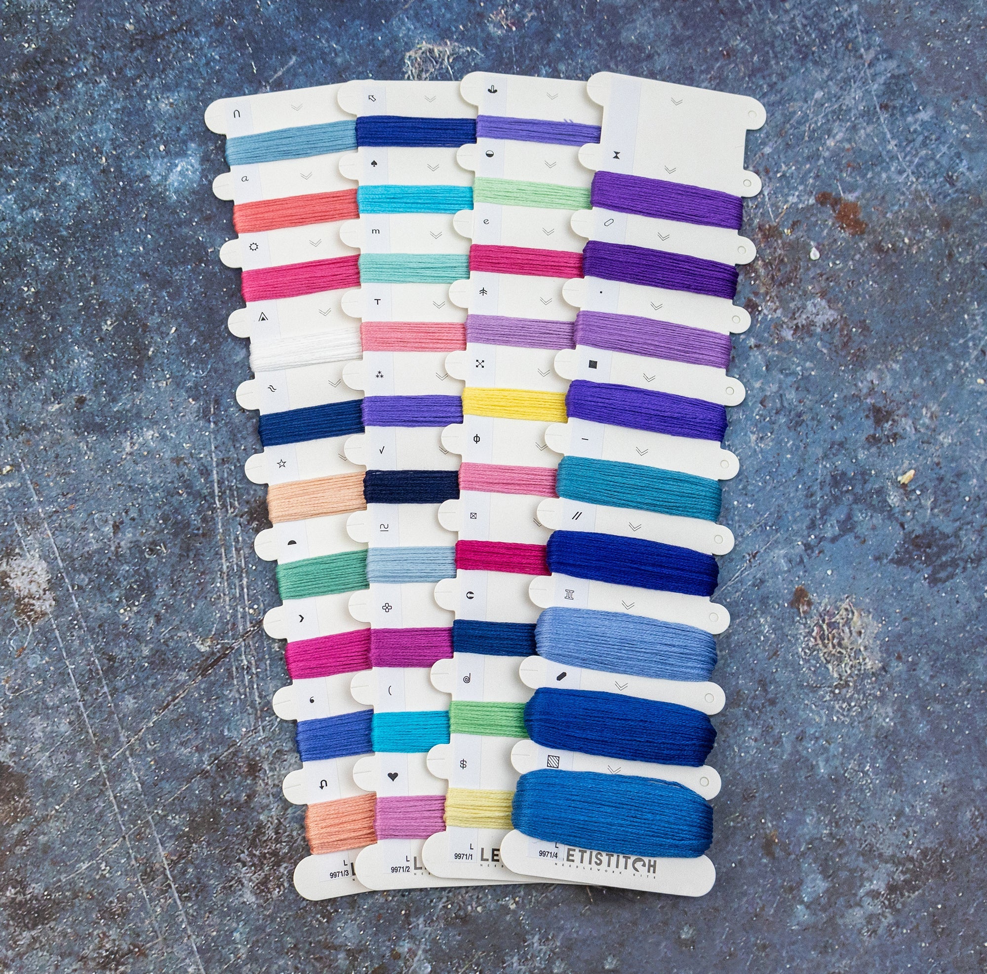 Color swatch card with various yarn colors on a textured surface