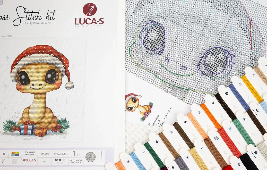 Cross stitch kit with a cute dinosaur design and color chart on a white background.