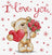 Cross-stitched design of a teddy bear holding roses and a heart with 'I love you' text.