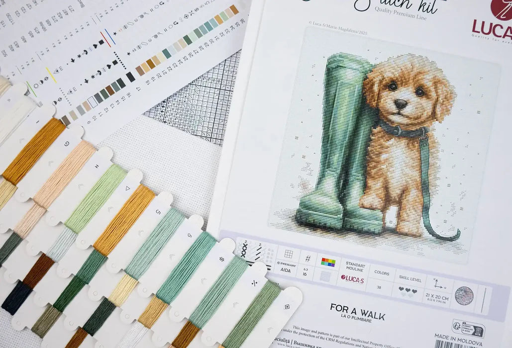 Cross-stitch kit with a dog illustration and color swatches on a white background