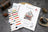 Cross stitch kit with color chart and packaging on a textured surface