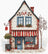 Cross-stitched design of a charming cafe with a red and white striped awning.