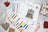 Cross stitch kit with colorful threads and pattern chart on a textured surface.