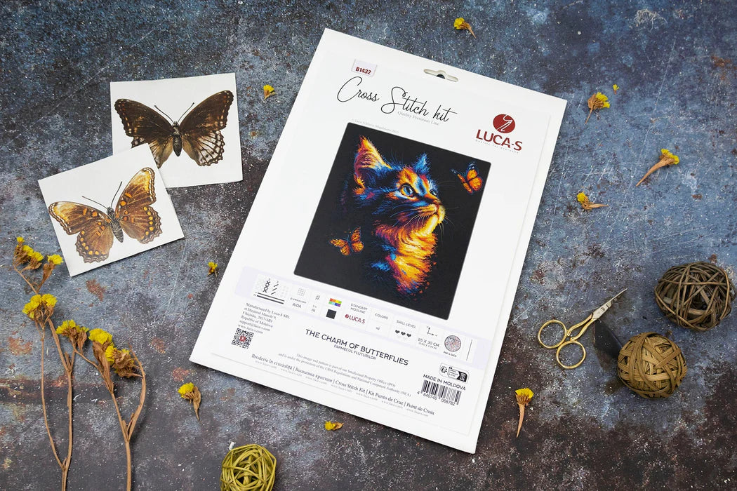 Cross stitch kit for 'The Charm of Butterflies' by Luca's on a textured surface with butterfly images and crafting materials.