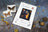Cross stitch kit for 'The Charm of Butterflies' by Luca's on a textured surface with butterfly images and crafting materials.