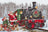 Christmas-themed train with Santa Claus on a snowy landscape