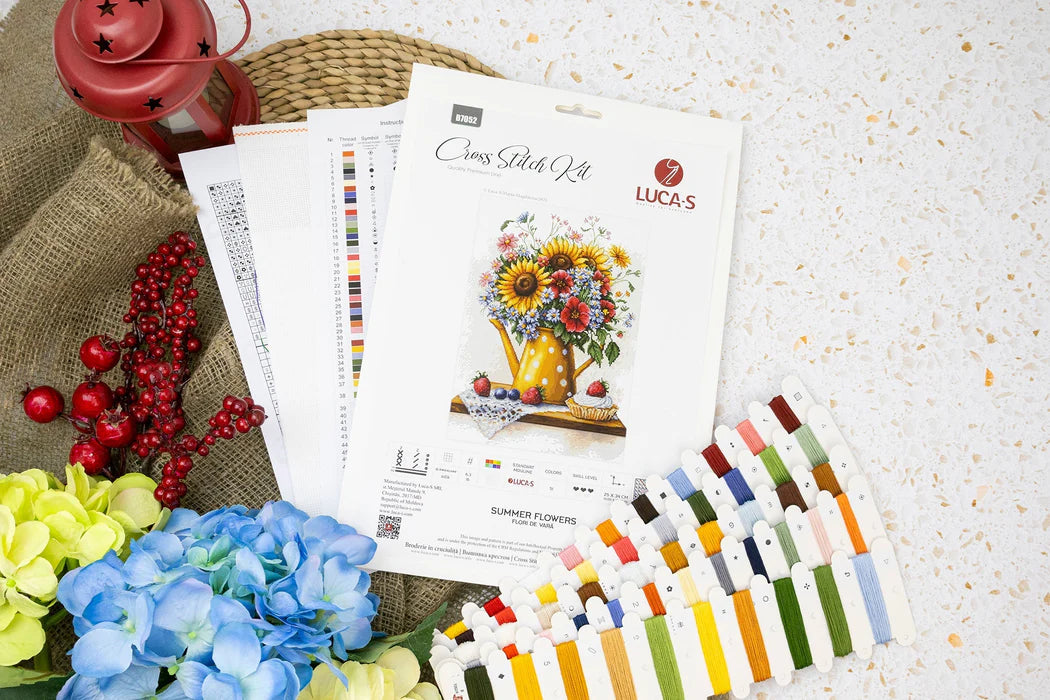 Color swatch book, floral design paper, and floral decorations on a textured surface