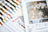 Color swatches and a painting of white flowers in a vase on a table.