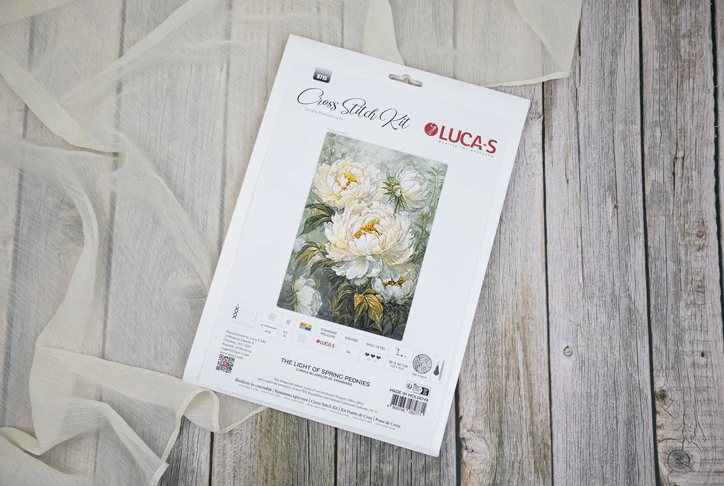 Lucas cross stitch kit packaging on a wooden surface with floral design