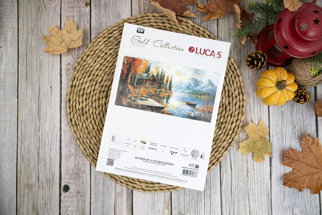 Lucas Gold Collection cross-stitch kit on a wooden surface with fall decorations
