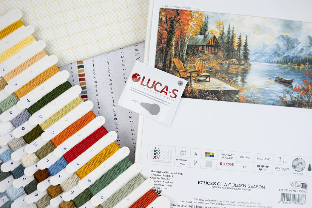 Color swatch book with embroidery thread colors and a painting of a cabin by a lake.
