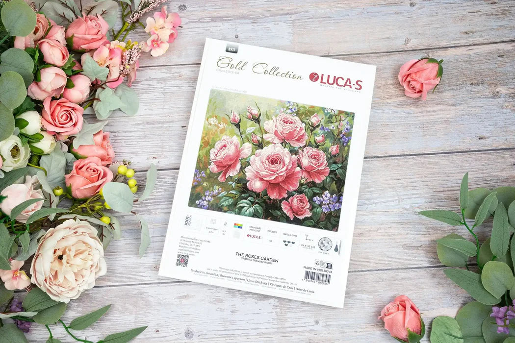 Floral arrangement with a Lucas Gold Collection packaging on a wooden surface