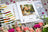 Lucas embroidery kit with color chart and floral arrangement on a wooden surface