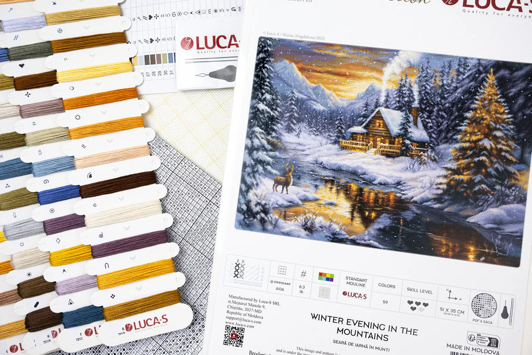 Color swatch book and cross stitch pattern of a winter scene with a cabin.