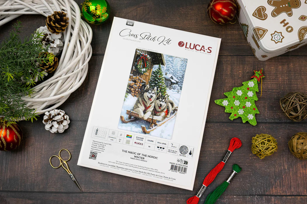 Christmas-themed craft kit with instructions and decorative items on a wooden surface