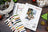 Lucas embroidery kit with threads and pattern on a wooden surface with Christmas decorations.