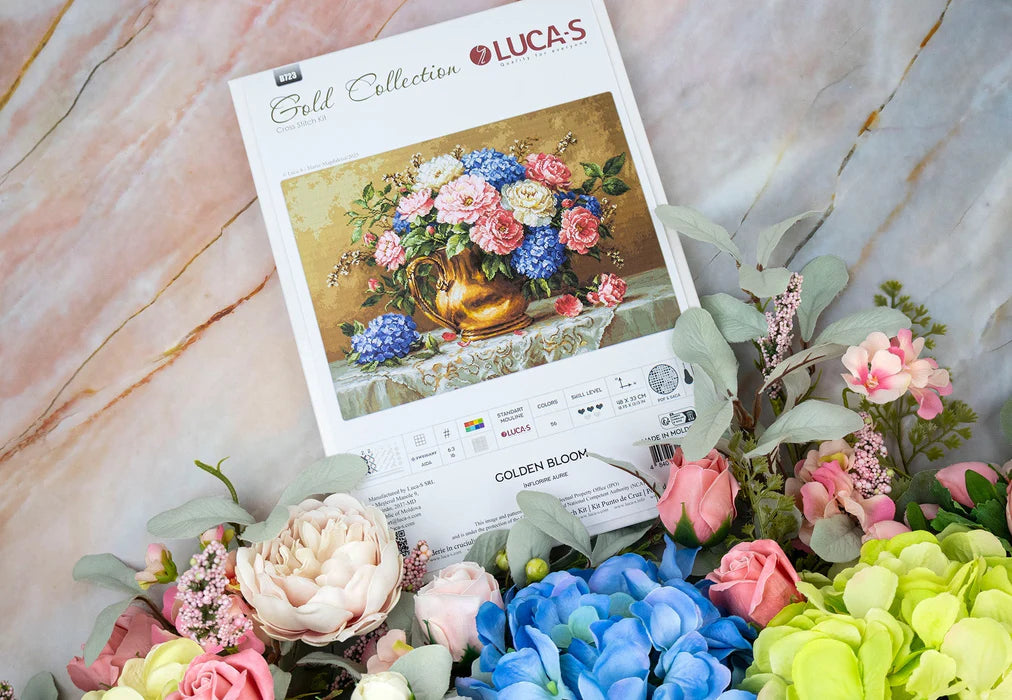 Lucas Gold Collection cross-stitch kit with a floral design and decorative flowers on a marble surface