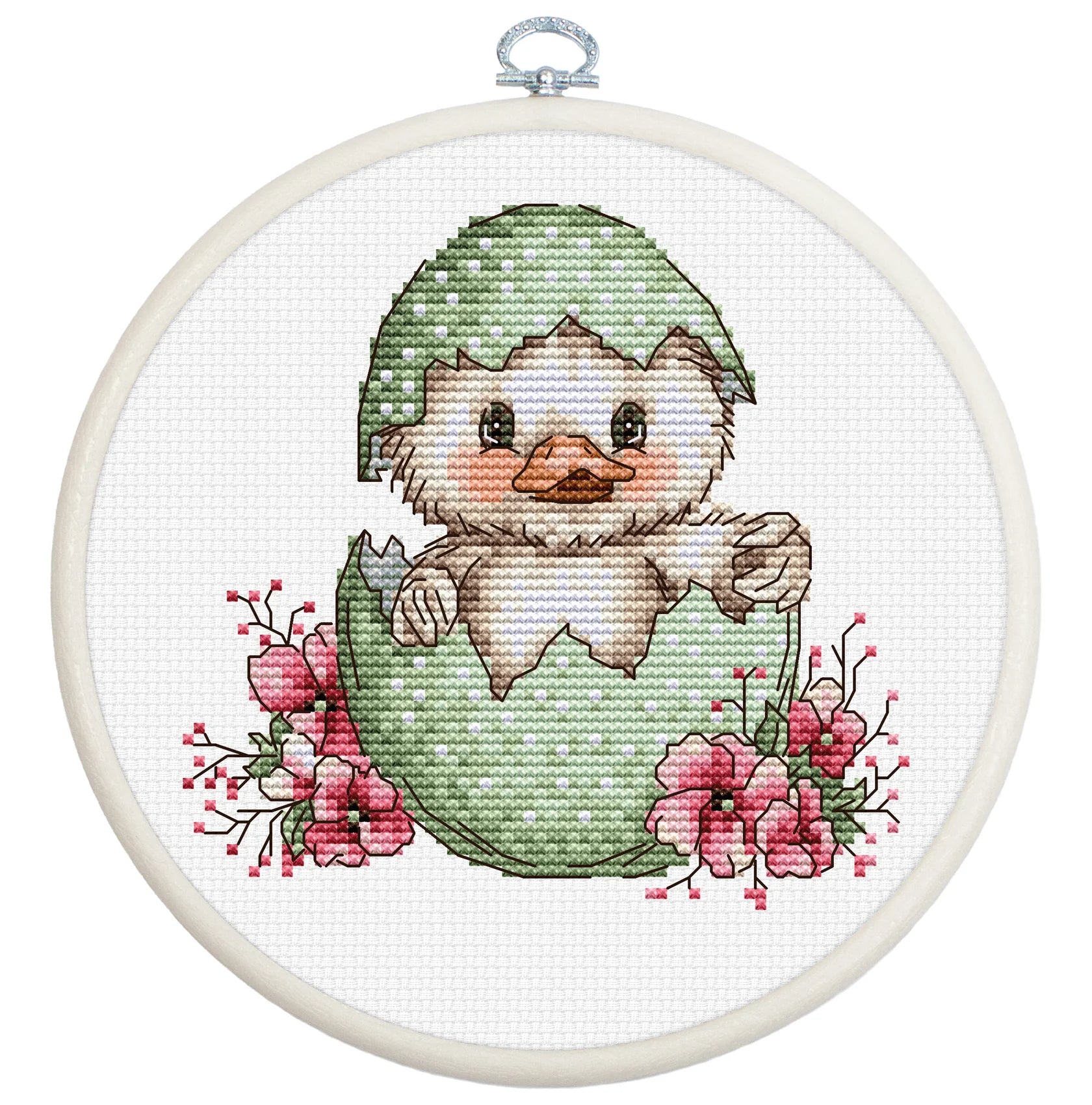Cross-stitched design of a duckling in an egg with flowers, framed in a white hoop.