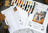 Cross stitch kit with pattern chart and wolf design on a textured surface.