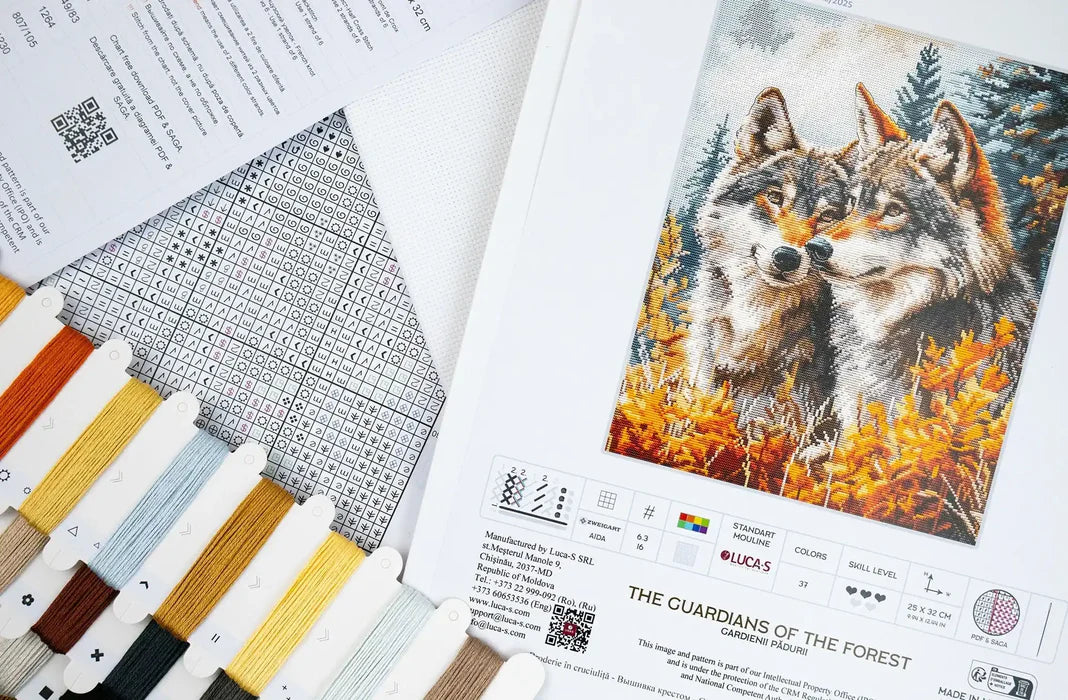 Cross-stitch pattern with two wolves in a forest and color swatches.