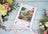 Lucas cross-stitch kit on a wooden surface with flowers and ribbons