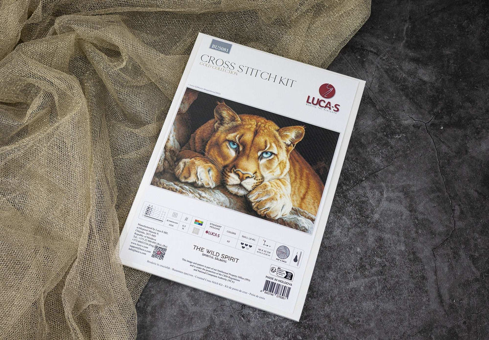 Cross stitch kit packaging featuring a lion on a textured fabric background