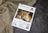 Cross stitch kit packaging featuring a lion on a textured fabric background