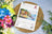 Cross stitch kit by Luca's on a woven mat with flowers around