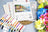 Cross stitch kit with thread set and colorful flowers on a blue surface