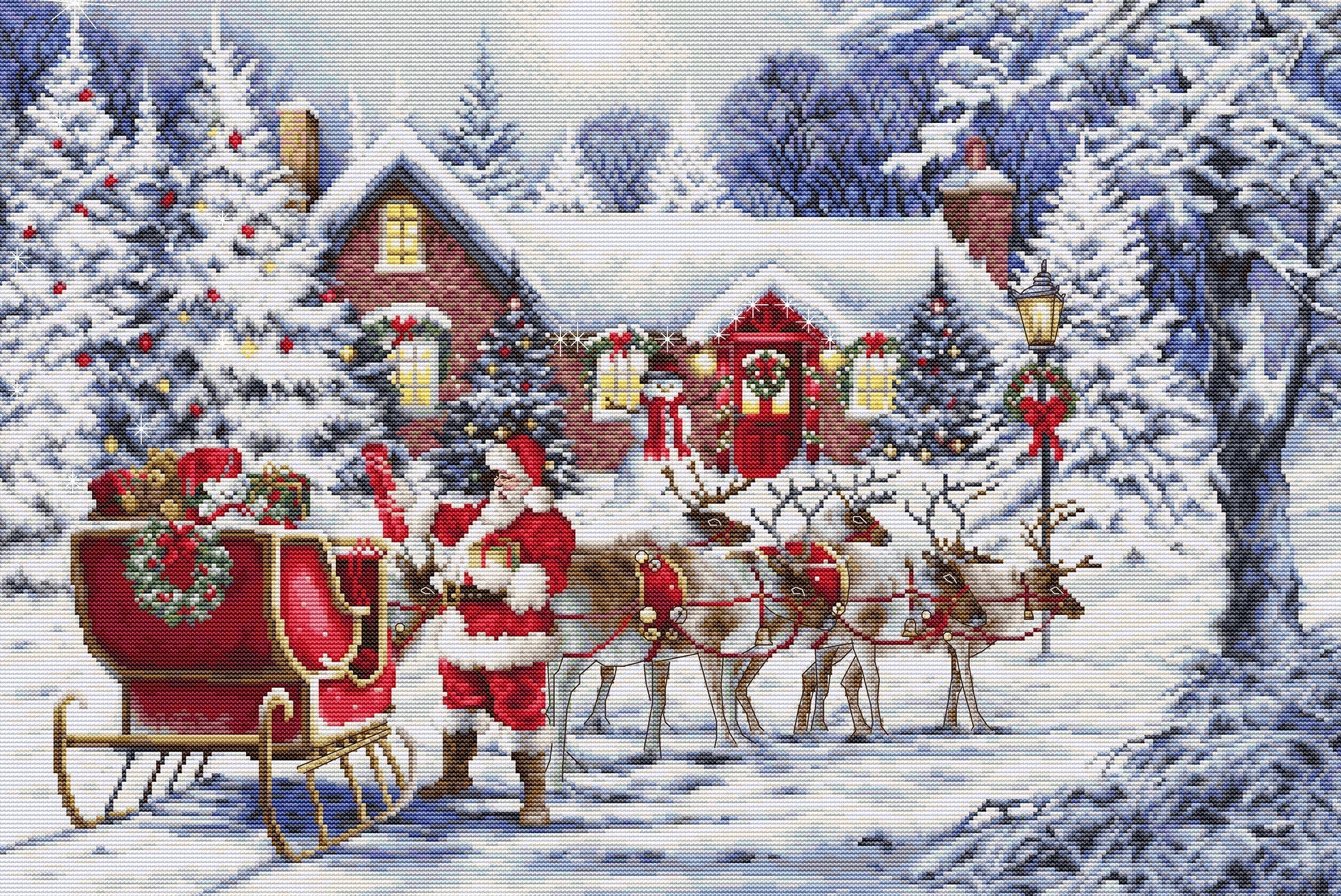 Cross-stitched scene of Santa Claus with reindeer and sleigh in a snowy village.