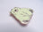 Green bear-shaped pin on a light gray background