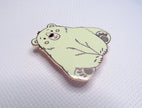 Green bear-shaped pin on a light gray background