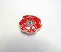 Red poppy flower needleminder on a textured white background