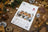 Lucas cross-stitch kit for three owls on a wooden surface with decorative elements.