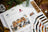 Lucas cross-stitch kit with owl design, color swatch, and Christmas decorations.