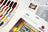Lucas cross stitch kit with color swatches and pattern sheets on a white surface