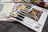 Color swatch book with fabric samples and a photo of a person wearing a colorful scarf.