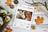 Lucas Gold Collection packaging with a deer and woman design on a wooden surface with fall leaves and branches.
