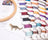Colorful embroidery thread spools on a white surface with a wooden hoop and leopard pin.