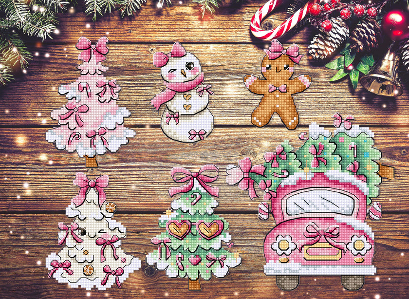 Cross-stitched Christmas-themed ornaments on a wooden surface with festive decorations.