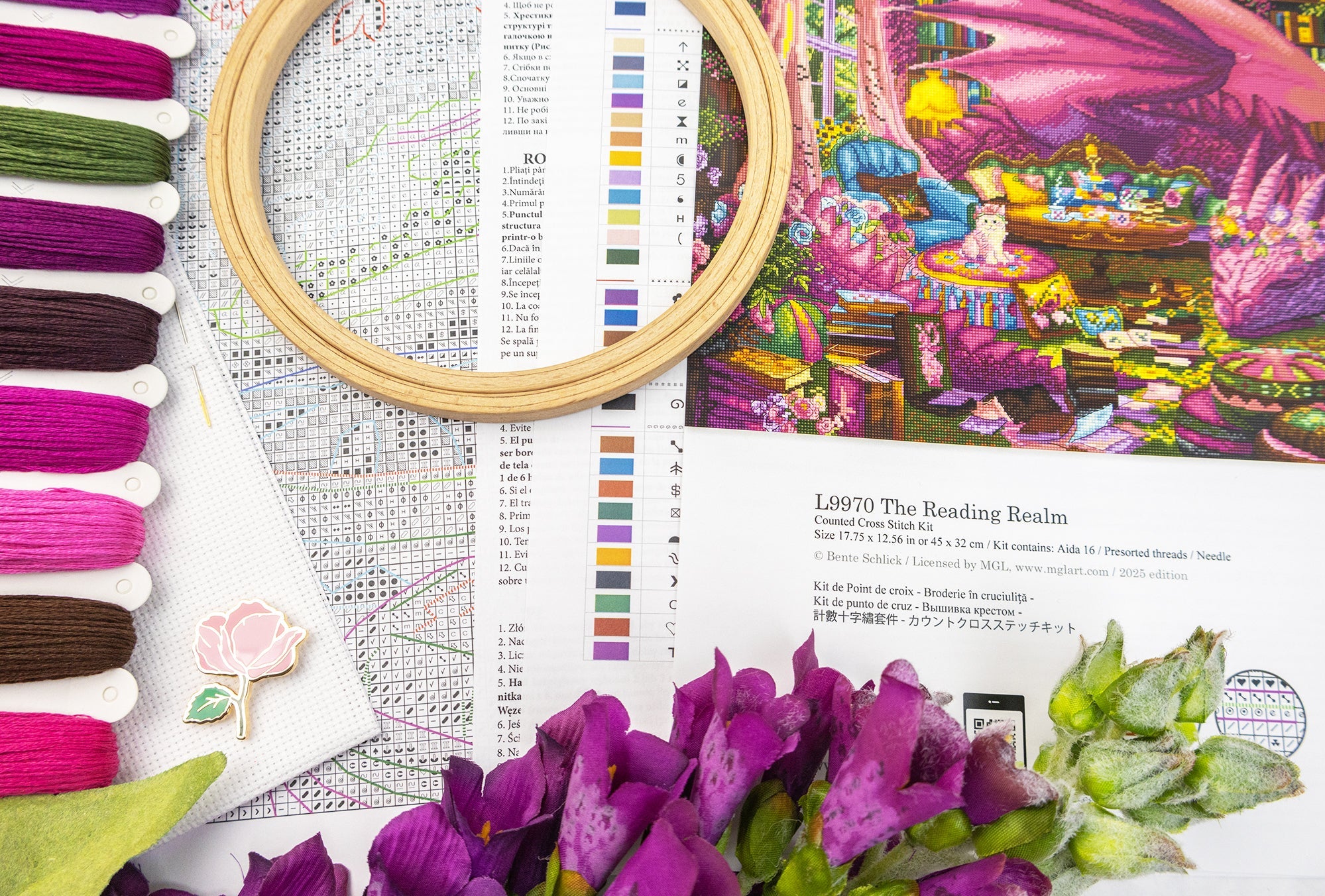 Embroidery hoop, fabric swatches, and floral elements on a table with a colorful embroidery design.